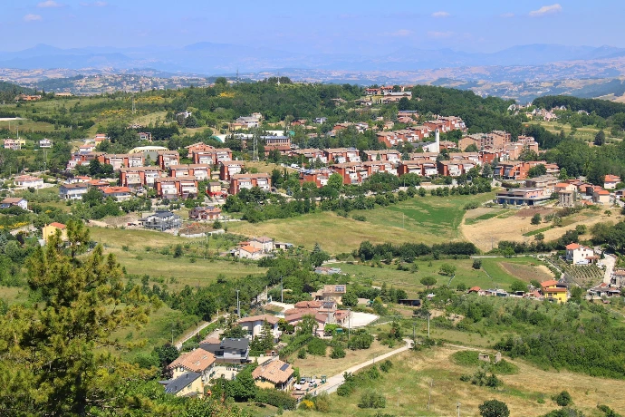 A small town nestled in a valley surrounded by trees